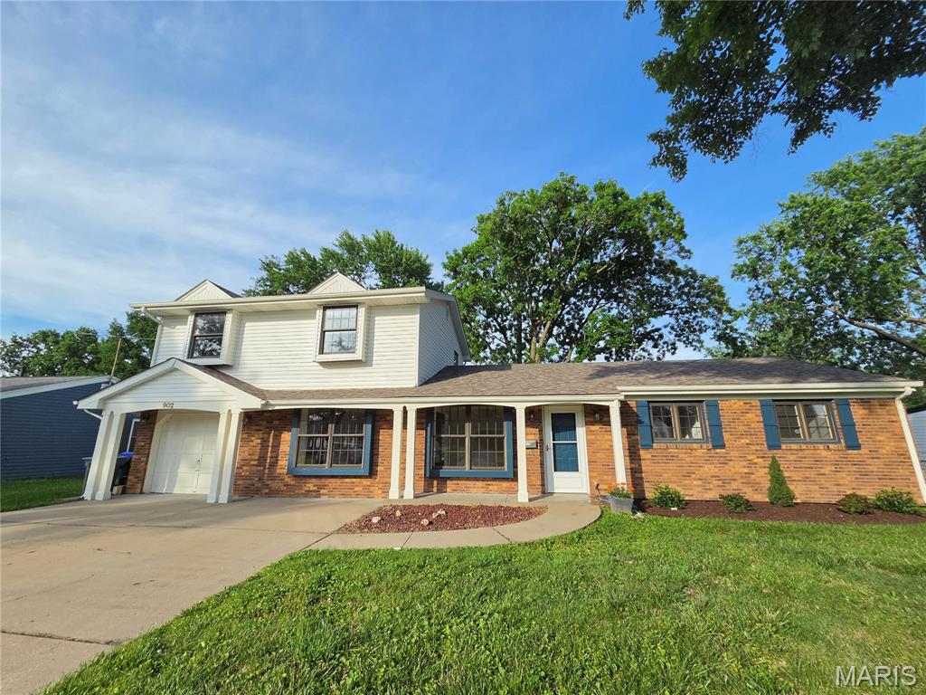 Beautiful 5-bedroom, 2.5-bath home featuring a spacious open floor plan and charming covered front porch. Inside, you’ll find neutral paint colors and an abundance of natural light throughout. The updated kitchen is the heart of the home with white custom cabinetry, granite countertops, stainless steel appliances, and direct access to the level backyard — ideal for outdoor entertaining, play, or relaxing evenings. The inviting family room features a cozy brick fireplace with a classic white mantel, creating the perfect gathering space. The updated bathrooms offer modern finishes and added style, while the generous bedroom layout provides plenty of space for family, guests, or a home office. Clean, well-maintained, and truly move-in ready, this home combines comfort, style, and functionality in every room.