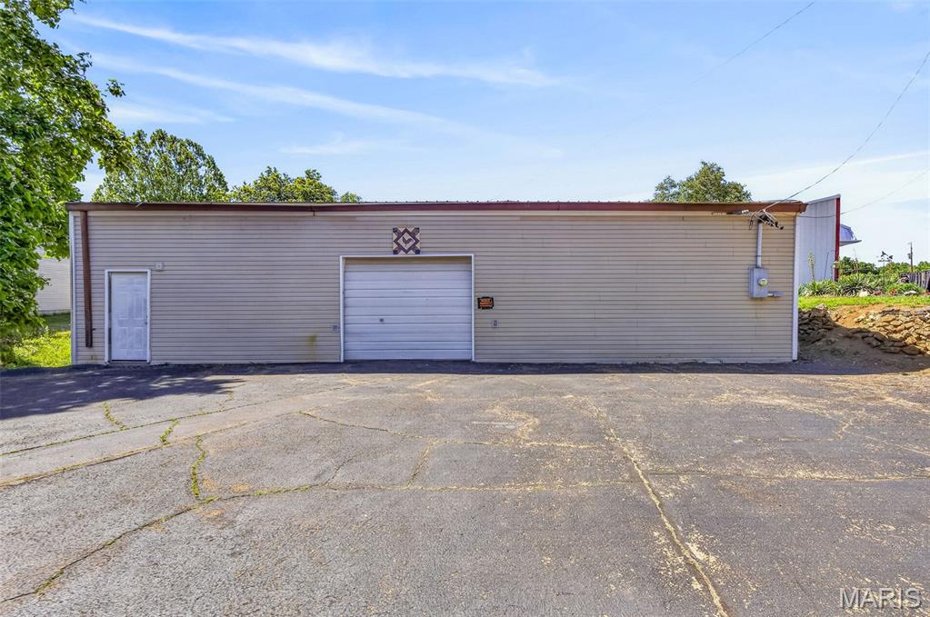 Endless possibilities await at 303 5th St in Park Hills, Missouri! This versatile commercial property offers over 2,200 sq ft of functional space ready to fit a variety of business or investment needs. Inside, you'll find a bathroom, a separate room ideal for an office or potential living space, plus a spacious garage area complete with an overhead door, storage shelving, workshop area, and HVAC system. The property also features ample parking in both the front and rear, providing convenience for customers, employees, or equipment access. Whether you're looking to expand your business, start a new venture, or invest in flexible commercial space, this property offers incredible potential. Property is being sold as-is.
