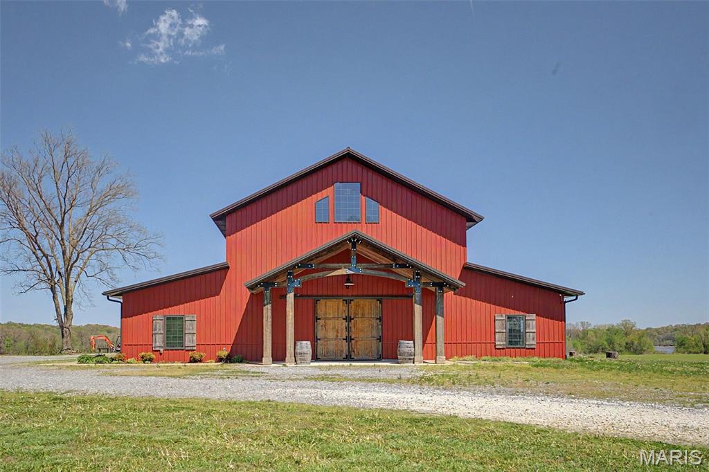 Introducing a great business opportunity with real estate in Scott City, MO!  Discover the natural beauty of Southeast Missouri at Amor on the River, a premier wedding and event venue nestled on the banks of the mighty Mississippi River.  Perched on a hill with breathtaking panoramic views of the river, passing barges, and historic trains crossing the Thebes Bridge, this property offers an unforgettable setting.  Featuring 6,700 square feet of versatile event space in an elegant barn-style building, full commercial kitchen with walk-in cooler, and a 1,470 square foot 2 bedroom, 2.5 bath apartment on the second floor which serves newlyweds and Airbnb customers like, this property has multiple revenue streams.  The building sits on 1.64 acres of gorgeous riverfront land with Mississippi River views, ideal for weddings, receptions, corporate events, private parties, and more.  Guests enjoy the peaceful sounds of the river, stunning sunsets, and the unique charm of watching river traffic and trains go by. The property’s elevated position provides sweeping, unobstructed views that make every event feel magical.  This turnkey venue is fully equipped and ready for continued success as a profitable business.  It has an established reputation as one of Southeast Missouri’s most sought-after wedding destinations, with strong potential for growth through expanded events and regular overnight accommodations.  Whether you're an investor, event professional, or someone dreaming of owning a slice of riverfront paradise, Amor on the River represents a rare opportunity to own a piece of Missouri history with modern event appeal!