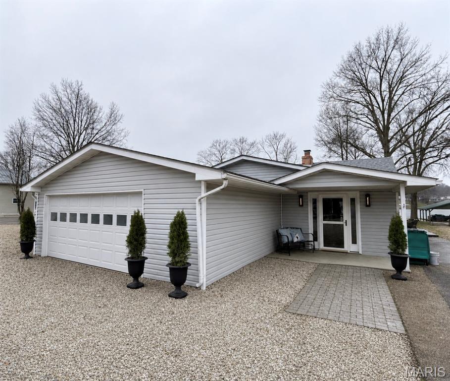 This beautifully remodeled 3 bedroom, 1 bathroom home sits on a flat, waterfront lot with direct lake access, a private boat dock with boat lift. The property includes an asphalt driveway, two-car garage or recreational room, and storage shed. With a brand-new roof, updated electrical and plumbing systems, modern HVAC, and a gas water heater. Updated kitchen with custom granite countertops, rich oak cabinetry, sleek appliances, and thoughtfully chosen hardware and fixtures. Unique engineered wood floors, quality interior doors, cordless top-down/bottom-up cellular shades, and thermal curtains. Whirlpool washer and dryer provide to add convenience. The outdoor spaces is perfect for entertaining features a large back porch with a bar, two concrete patios with pergolas, and breathtaking lake views right from your backyard. Enjoy the 326-acre lake nestled in a welcoming lake community with top-notch amenities.