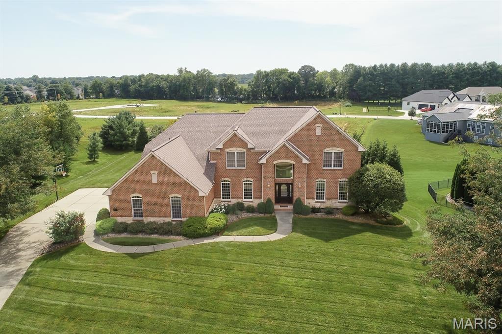 WELCOME TO THIS IMPRESSIVE ALL-BRICK 5-BEDROOM, 6-BATH HOME OFFERING OVER 5,000 SQUARE FEET OF BEAUTIFULLY FINISHED LIVING SPACE ON A CUL-DE-SAC LOT IN THE PRESTIGIOUS CHATEAUX AT WOODFIELD! Designed with both everyday living and entertaining in mind, the main level welcomes you with a dramatic two-story great room featuring dual staircases and a gas fireplace, along with a private home office and formal dining room. A versatile bonus room tucked just off the great room is currently used as a playroom but could easily serve as an additional office, fifth bedroom, sitting room or flex space.

The kitchen offers abundant space for gathering and entertaining, featuring a large 8-foot island, double ovens, cooktop, newer dishwasher and generous prep and storage space. The breakfast nook opens to the private backyard, deck and view of the oversized heated saltwater pool.

The primary suite is a true retreat with a spacious bath featuring a large tiled shower with dual shower heads, jetted tub, dual sinks, and a large walk-in closet. Three additional spacious bedrooms round out the upstairs, including one with a private bath and two connected by a jack-n-jill bath.

As if that's not enough, you will love the impressive, finished walk-out lower level that was made for entertaining! A beautiful stone bar is fully equipped with an ice maker, refrigerator drawers, dishwasher, double kegerator and more, while the expansive family and recreation area is highlighted by a five-TV wall that is any sports fan’s dream and offers plenty of space for game days and gatherings. One of the home's most unique features is the dedicated indoor turf recreation room-currently set up for soccer, but offering endless possibilities for sports training, exercise, games or additional recreation space. A full bath with a luxurious rain showerhead completes the lower level, with direct access to the backyard and pool area.

Major updates include a NEW roof in 2024, water heater in 2023, newer pool liner and equipment, updated HVAC components, fresh paint and more. An oversized three-car, side-load garage with epoxy flooring and a tree-lined backdrop complete this exceptional property. So much space, so many updates, and an incredible setup for entertaining inside and out. With its 100% brick construction, finished walk-out lower level, and large resort-style pool, this home offers a level of quality, space, and amenities that cannot be replicated at this price point. Don’t miss this exceptional opportunity!