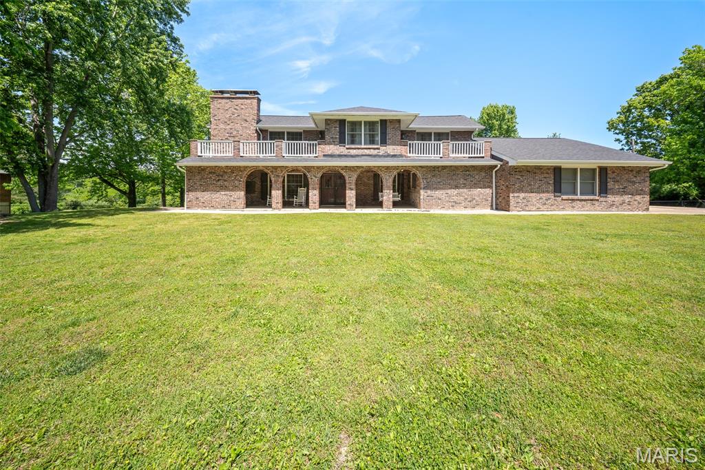 Welcome home to this stunning handicap accessible 3-bedroom, 3-bathroom retreat ideally located just minutes from all that Rolla has to offer, yet tucked away on a quiet dead-end road for added privacy. Situated on an amazing oversized lot, this property offers the perfect blend of convenience and peaceful living. The new roof and guttering in 2025 offer peace of mind. Step inside to find beautiful wood flooring and a warm, inviting living room featuring a cozy wood-burning fireplace. The main level hosts a spacious primary suite along with a full guest bathroom, offering comfort and convenience. The kitchen is well-equipped with stainless steel appliances—featuring a new refrigerator in November 2025 —and offers a center island with breakfast bar seating (optional to stay), perfect for meal prep or gathering with family and friends. Upstairs, you’ll find two additional bedrooms and a full bathroom, providing plenty of space for family or guests. Sellers are willing to make the few minor modifications needed to the main-level bathrooms to restore handicap accessibility, providing added convenience and accessibility for the next owner.   Entertain with ease in the unique bar area, complete with its own fireplace (bar area optional to stay), creating the perfect atmosphere for hosting. Additional features include a laundry room with hanging ladder, and a hot tub that stays—perfect for relaxing evenings at home. Outside, the huge backyard offers endless possibilities, complete with a charming playhouse that conveys with the property. This one truly has it all—space, charm, and an unbeatable location!