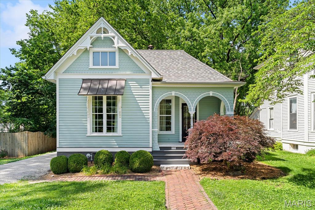 A rare offering in Edwardsville's prestigious St. Louis Street Historic District, this exquisitely restored circa-1900 home captures the elegance of a bygone era while embracing the comforts of modern living. Rich architectural details, soaring ceilings, intricate exterior millwork, and a welcoming front porch create an unforgettable first impression. Inside, sun-filled living spaces showcase hardwood floors, oversized windows, and timeless craftsmanship. The kitchen features granite countertops, custom cabinetry, stainless steel appliances, and an adjoining breakfast nook designed for both everyday living and entertaining. A spacious main-floor primary suite, additional bedroom, and two full baths provide exceptional flexibility, while the expansive upper-level bonus room offers endless possibilities for work, recreation, or guest accommodations.

Outdoors, an elevated deck overlooks a beautifully fenced backyard framed by mature trees, creating a private retreat in the center of town. Situated moments from downtown Edwardsville's celebrated dining, shopping, and entertainment destinations, this remarkable residence offers a rare combination of historic significance, modern convenience, and enduring character. A truly exceptional opportunity to own a piece of Edwardsville history. Before making an offer on any property, buyer should independently verify all MLS data derived from various sources and not warranted accurate.  Fireplace located in dining room has been sealed and does not work.