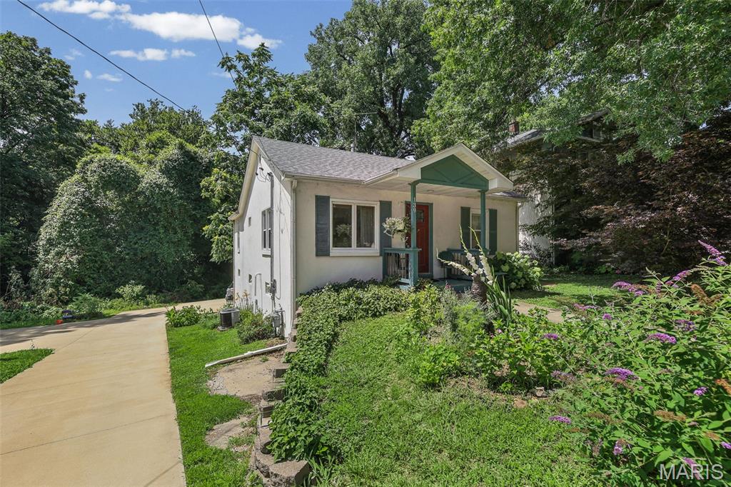 Charming, full of character, and tucked into one of Edwardsville's most convenient locations, this beautifully maintained home is just minutes from downtown shops, restaurants, parks, and community events. Inside, you'll love the warm, inviting feel, with gorgeous hardwood floors throughout most of the main level, abundant natural light, and an updated eat-in kitchen featuring plenty of cabinet and counter space. The home's relaxed, boho-inspired vibe makes it feel instantly welcoming. The walkout basement is clean, dry, and offers fantastic potential for additional living space, complete with a partially finished bonus room that's ready to be your next office, play room, guest space, or yoga studio. Plenty of off-street parking is conveniently located behind the home. Additional updates include radon mitigation already installed, a newer oven (2026), and a roof believed to have been replaced around 2024. If you've been looking for a home with charm, personality, and an unbeatable Edwardsville location, this is it!