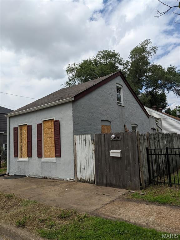 Built in 1892, this 1.5-story home offers classic character and an opportunity for someone to bring back its charm. The home features a classic brick and vinyl exterior, solid stone foundation, 2 bedrooms, 1 full bath, and the convenience of main-floor laundry. A slider opens directly to the expansive backyard, which includes a privacy fence along with side and rear patios. This property offers plenty of potential for an investor or buyer looking for a renovation project with original character and a spacious outdoor area. The unfinished basement provides additional storage or potential for future use. Conveniently located just minutes from Highway 55 and public transportation, the property offers easy access while remaining in a residential setting. Property is being sold AS IS. Seller to do no inspections or repairs.