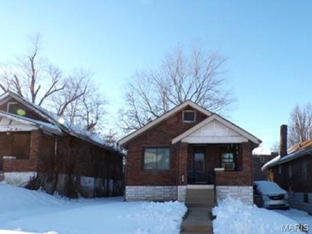 This brick bungalow offers approximately 960 square feet of living space and features 2 bedrooms, 1 bathroom, and an unfinished basement, providing additional storage or future improvement potential. OCCUIPIED NO ACCESS TO INTERIOR OF ANY KIND. Please DO NOT disturb the occupant. AS IS CASH ONLY. Built in 1930, the home showcases a traditional exterior with a covered front porch and timeless brick construction. Situated on an approximately 4,069-square-foot lot, the property includes a manageable yard. Great opportunity for owner-occupants, investors, or buyers seeking a home with classic charm and potential. Buyer to verify all information, including square footage, and lot size. AUCTION PROPERTY.