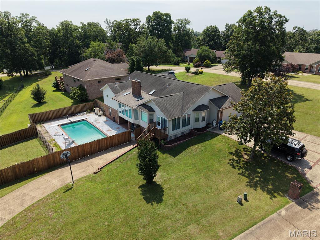 Open House 07/07/2026 - 3553 Tanglewood Road, Poplar Bluff MO.
Welcome to an exceptional single-family home situated on a 1.07-acre corner lot in Poplar Bluff’s hidden McLane Oaks subdivision. Offering over 4,400 square feet of total living space, this carefully maintained 5-bedroom, 3.5-bathroom residence  combines spacious interior design, everyday comfort, and seamless outdoor living.

The light-filled main level features an open layout with three generous bedrooms and two and a half bathrooms, including a relaxing primary suite. At the heart of the main floor is an inviting living room anchored by a cozy fireplace—perfect for quiet evenings or entertaining guests. Broad windows and thoughtful finishes elevate the space, creating a warm atmosphere throughout the main living areas. A four-seasons porch overlooks the private backyard pool area below. 

Extending your living space even further, the finished walk-out basement includes two additional bedrooms/sleeping areas, a full bathroom, wet bar / kitchenette, additional garage / workshop and expansive storage space. Step outside into your personal backyard sanctuary, featuring a private in-ground pool ideal for warm summer days, weekend entertaining, and relaxing outdoors. Complete with an attached two-car garage, public utilities, and an unbeatable location within walking distance of McLane Park, healthcare and shopping, this property is ready to welcome its next owners.
