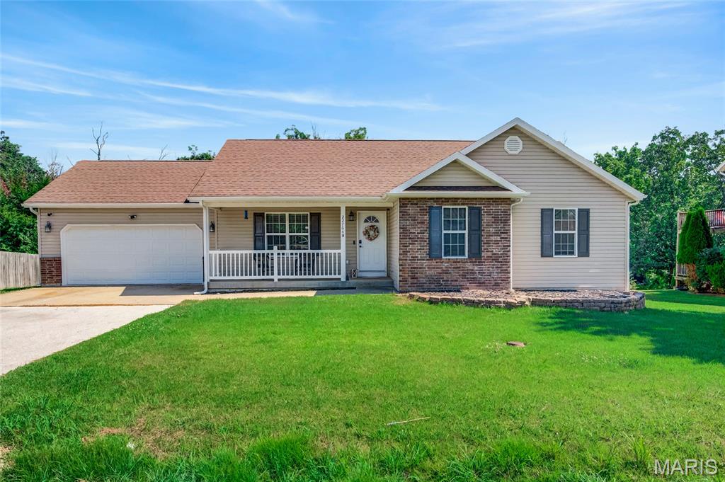 Welcome home to this spacious 4-bedroom, 3-bathroom home offering over 2,600 square feet of comfortable living space sitting on .59 acres, thoughtfully designed for both everyday living and entertaining. Start your mornings with a cup of coffee on the inviting front porch before stepping inside to discover a functional layout with room for everyone. The incredible walk-out basement features a large second living area along with a private bedroom and full bathroom, making it the perfect space for guests, multi-generational living, or a home office. Step outside and enjoy the oversized 28' x 11.5' deck overlooking a backyard and wooded area, providing added privacy and peaceful views. Down below, you'll find a massive 25' x 23' concrete patio that's ideal for barbecues, outdoor entertaining, or simply relaxing at the end of the day. Enjoy all the opportunities provided through the Waynesville School District, this home is just a short drive to Fort Leonard Wood, Roubidoux Park, and the shopping, dining, and entertainment of downtown Waynesville. With generous living space, exceptional indoor and outdoor entertaining areas, and a location that's hard to beat, this home is ready to welcome its next owners!