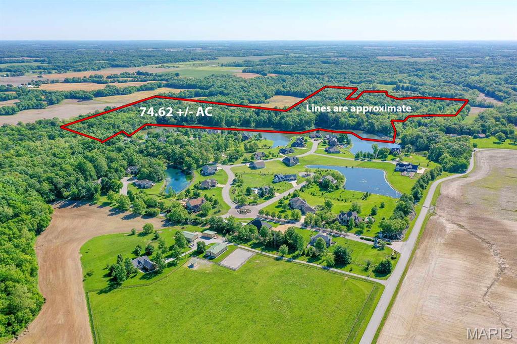 Price listed is Starting Bid Only. Bidding starts closing 6/30/2026 @ 5 p.m. Rare opportunity to acquire these 74.62± acres of wooded land offering residential development potential, income generation through harvesting mature timber, or exceptional recreational use in Columbia, IL! The property is accessed off Wiltshire Drive within the highly sought-after Stonehenge Subdivision, conveniently located between Columbia and Millstadt and just minutes from IL-3 and IL-158. This scenic tract features waterfront frontage along the subdivision lake along with a cleared path providing access through the acreage, making it ideal for exploring, hunting, or future residential development. Public water, public sewer, and connection to the community propane system are all available to the property, enhancing its development potential and reducing infrastructure costs for future improvements. The property is zoned A-Agriculture and falls within the St. Clair County zoning jurisdiction. Any use not currently permitted under the existing zoning classification would require approval from St. Clair County authorities. An annual HOA/LOA assessment of approximately $4,173 applies for lake maintenance and is prorated based on shoreline frontage. The property also benefits from a shared easement for dam maintenance utilized by the Stonehenge LOA. Because the dam is owned and maintained by the LOA, access across the easement is required periodically, typically once or twice per year, to allow for inspections and maintenance activities. This easement may be vacated in the future if streets are constructed as part of a development plan, and any future roadway layout would not be required to follow the existing easement alignment. The property presents significant development opportunities, including a proposed subdivision layout that was approved by the City of Columbia in 2023. Updated approval from the Columbia Plan Commission and City Council would still be required prior to development. Any prospective buyer should be aware that development of this property will require initiation of a new subdivision approval process, including submission of a new preliminary plat, review by the Columbia Plan Commission, and approval by the Columbia City Council to ensure compliance with all current zoning regulations, subdivision ordinances, and comprehensive planning objectives. While county approval would also be required, the proposed concept conforms to current zoning regulations and applicable state and local requirements and would not require zoning variances. Buyers should also note that a bridge serving the area is not located on this parcel; however, St. Clair County has previously indicated that inclusion of the bridge within the National Bridge Inventory may be required before any future parcel splits are approved. A recent bridge inspection report is available for review. The bridge provides access to the dam maintenance area and is associated with the Stonehenge LOA's ongoing inspection and maintenance obligations. Conveniently situated within Millstadt Community Consolidated School District 160 and Belleville Township High School District 201, this property combines natural beauty, privacy, waterfront amenities, available utilities, and substantial future development potential in one of the area's most desirable locations. Any prospective buyer should be aware that development of this property will require initiation of a new subdivision approval process, including submission of a new preliminary plat, review by the Columbia Plan Commission, and approval by the Columbia City Council to ensure compliance with all current zoning regulations, subdivision ordinances, and comprehensive planning objectives. Property will sell under auction terms and be sold AS- IS, WHERE-IS. Buyer will be required to sign an Auction Purchase & Sale Agreement if final bid is accepted by Sellers.