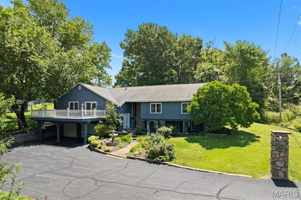 Discover the incredible potential this spacious property has to offer, perfectly situated on two parcels totaling approximately 1.3 acres for added room to spread out. Outdoor spaces abound, with a large front deck, covered side porch, detached garage for additional storage, and an oversized tuck-under garage with space for two vehicles, plus plenty of extra room for tools, hobbies, or equipment.
Inside, the main level features a generous and functional floor plan with formal living and dining rooms, a kitchen that opens seamlessly to the family room, and an additional versatile bonus room ideal for a home office, den, hobby room, or playroom. A separate laundry area adds convenience to everyday living. The spacious primary suite offers two closets and a private bath, while two additional bedrooms, a full bath, and a half bath complete the main level. The lower level adds even more flexibility with a finished room featuring a closet, along with additional unfinished storage space. With its substantial square footage, expansive lot, and endless possibilities to update and make it your own, this property presents a fantastic opportunity for buyers seeking space, value, and potential. Property is being sold as-is; seller will make no repairs or complete government inspections. Agent related.