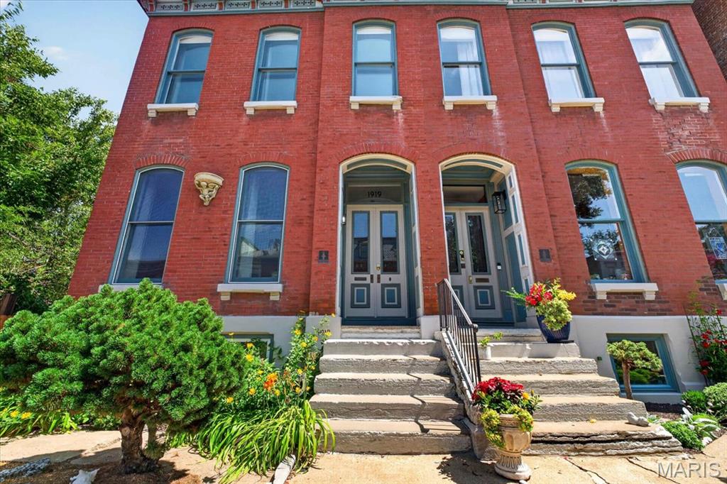 NEW PRICE AND READY TO GO! Welcome to a rare find in Historic Lafayette Square. Located on a sought after street known for it's beautiful "Painted Ladies", this home has been meticulously cared for and improved with all newer roofs, zoned HVAC systems, upgraded kitchen and newer decks. A rarer find is the 2 car attached heated & cooled tandem garage and 1 additional space off the alley. Something unheard of in this neighborhood. The main floor features a large living room and dining room separated by working pocket doors. Hardwood floors are found throughout the main and 2nd levels. Soaring ceilings and historic moldings are everywhere. The main floor rear area is a huge kitchen with tons of cabinets open to the family room which had an 8' tall sliding door onto the large deck for entertaining. Beyond the deck is another large storage room, perfect to over-winter plants and pots. The spacious primary suite features, a dressing room with two huge closets, a laundry and separate bath ensuite. There are two additional bedrooms and a large hall full bath on this floor. The 3rd floor is one large attic space for storage and systems. The lower level at grade is the garage, large mudroom / laundry area, utilities room, and then a large open rec room with a 2nd kitchen area and a large full bath. There is a bonus room currently used as a guest bedroom. Having a 2nd exterior entrance, this area would make a terrific suite for inter-generational living. A narrow side yard makes for additional outdoor living space or a convenient space for the pooch to run. Enjoy the Summer Concerts in Lafayette Park, walk to restaurants and bars, and enjoy being 15 mins to everywhere! Convenient to SLU, The Cortex, Mid-town, and downtown. Don't miss this home in your search!