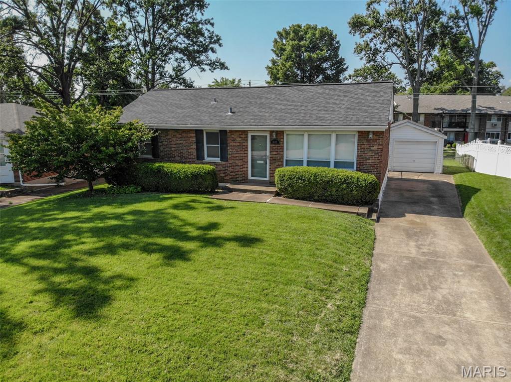Welcome home to this charming 3-bedroom, 1.5-bath brick ranch with a detached one-car garage, ideally located in the heart of Affton. Enjoy the convenience of this desirable South County location with easy access to I-55, making commuting and everyday errands a breeze. Step inside to a spacious living room filled with natural light from the large front windows. The pass-through opening to the kitchen creates an open, inviting feel that's perfect for everyday living and entertaining. The kitchen features maple cabinetry, Corian countertops, slate tile flooring, and a center island for added workspace and gathering. Beautiful hardwood floors run throughout the main level, which also includes three comfortable bedrooms and a full bath. The finished lower level expands your living space with a large recreation/family room, an updated half bath, and a versatile bonus room with built-in desks—ideal for a home office, playroom, or study area. You'll also find the laundry area and two separate utility/storage rooms, offering plenty of space for a workshop, hobbies, or additional storage. Step outside from the kitchen to the patio overlooking the large, level, fully fenced backyard—perfect for entertaining, pets, gardening, or simply relaxing outdoors. This well-maintained home combines comfort, functionality, and an excellent location, making it one you won't want to miss!