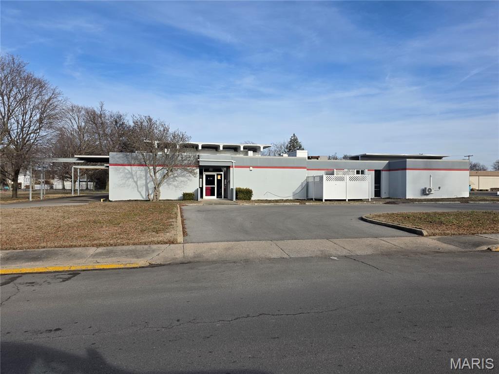 Large commercial building has been completely remodeled and is the ideal set up for professional or service-related offices.  This could be a single tenant or multiple tenants.  There are several entrances and parking on 3 sides.  The remodel included wiring, lights, electrical panels, bathrooms, and floors.  Fire alarm and sprinkler system are new.  Roof is about 75% new, and the parking lot has been resurfaced.  Large basement is accessible via an elevator or stairs and could be used for storage or additional offices.