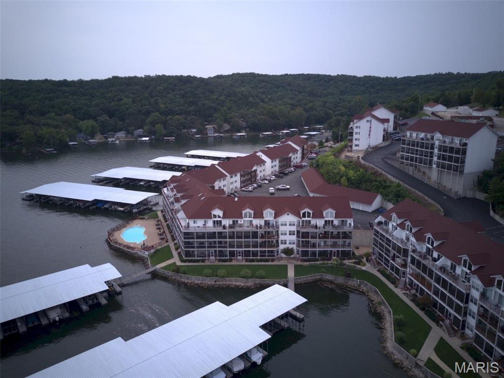 Located in the highly sought-after Clearwater Condominiums (Camdenton area) at the Lake of the Ozarks, this beautifully updated 5-bedroom, 4 full bath lakefront condo offers one of the best locations in the entire community. Situated on the ground floor, you’ll enjoy unmatched convenience with direct walk-out access to the lake, docks, pool, and your boat slip - all just steps from your oversized lakeside deck.
This move-in-ready condo has been fully remodeled with a brand-new kitchen, new flooring throughout, and a completely renovated master bathrooms. Additional upgrades include a newer high-efficiency HVAC system.
What truly makes this property unique is that it is the ONLY condo in the entire Clearwater community connected to the adjoining unit by both an interior door and exterior deck access. When purchased together with the neighboring condo, this creates an incredible 5-bedroom, 4-bath lakefront retreat featuring two kitchens, two living rooms, and an expanded double-sized deck - perfect for large families, entertaining, or investment potential as you can rent them out together or separately.
This unit can be separated by locking the demising doors and renting out the other side for great investment returns.
Included with the property is an extremely rare 40-foot boat slip — one of only six 40-foot slips available in Docks A–H along with a double Sea-Doo slip that comes with 600-1B. Large slips like this are nearly impossible to find in Clearwater.  
Clearwater Condominiums is known as one of the premier condo communities at the Lake of the Ozarks, offering outstanding amenities, beautiful grounds, excellent lake access, and a fantastic atmosphere for full-time living or vacationing.
A rare opportunity to own a truly one-of-a-kind lakefront property in the Heart of the Lake of the Ozarks.
