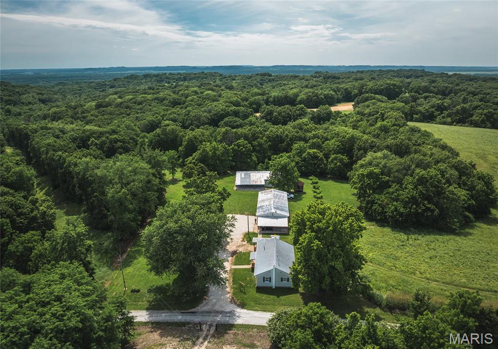 Opportunities to own a farm of this caliber are exceptionally rare. Spanning 378 acres located in North Calhoun County, Illinois, this premier hunting and recreational property has been developed and managed with one purpose in mind—producing and holding mature whitetail deer. Over the past several years, every aspect of this farm has been thoughtfully designed to maximize wildlife habitat. The property features 13 established food plots all strategically placed, 9 well-positioned hunting blinds, numerous treestands, extensive trail systems with gated access, and miscanthus grass screenings. Four ponds provide year-round water sources, while mature hardwood timber, diverse native cover, and thoughtfully established fruit tree plantings create exceptional bedding, feeding, and travel corridors.  73.88 acres are currently enrolled in CRP, generating annual income while simultaneously enhancing habitat quality. The result is a farm that consistently supports a healthy deer herd year after year. The hunting opportunities extend beyond deer. A healthy turkey population and abundant small game provide year-round recreational enjoyment for outdoor enthusiasts. Improvements on the property are equally impressive. The main residence offers a comfortable and updated 2-bedroom, 1-bath floor plan with an open-concept living area, making it an ideal hunting cabin or weekend retreat. Two outbuildings accompany the main home, providing ample storage for equipment and recreational vehicles. A second outbuilding is equipped with living quarters and utilities, creating additional guest accommodations. The property also includes an additional building site featuring an existing foundation, utilities, and another outbuilding, offering excellent potential for future expansion. Located just 1 hour and 40 minutes from Lambert International Airport, this extraordinary property combines world-class hunting, income-producing acreage, quality improvements, and unmatched habitat development into one complete package. For the buyer seeking one of the Midwest’s premier whitetail hunting farms, this is an opportunity that deserves serious consideration.