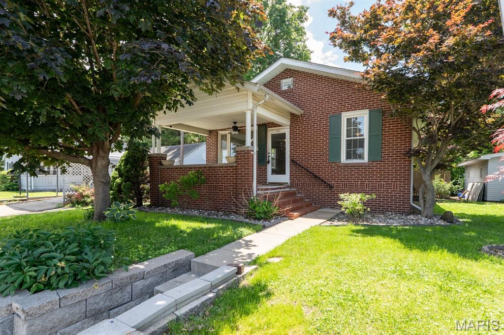 Open house canceled for June 14.  Sorry for inconvenience! Welcome home to this charming brick beauty nestled in a quiet neighborhood! Relax and unwind on the large covered front porch, perfect for morning coffee or evening gatherings. Inside, you’ll find a spacious living room with gas fireplace and plenty of room to entertain. The kitchen comes fully equipped with a refrigerator, microwave, dishwasher, and range, along with a convenient breakfast bar for casual dining or extra prep space. This home offers 2 comfortable bedrooms and an updated bathroom featuring a large walk-in tiled shower. Enjoy the convenience of laundry hookups on both the main level and in the full unfinished basement, providing flexibility and abundant storage space. The expansive family room offers additional living and entertaining space for movie nights, hobbies, or a home office setup. Outside, the fenced-in yard provides privacy and room for pets, play, or gardening. Parking is no issue with a 2-car attached garage plus an additional 1-car carport! High efficiency  AC and furnace less than a year old with 5 year factory warranty and Roof is less than 2 years old, with 5 years left on labor warranty! With its solid brick exterior, versatile layout, and peaceful location, this home is move-in ready and full of potential! Seller is willing to pass city occupancy, otherwise this will be sold as is.  Seller to do no other repairs.