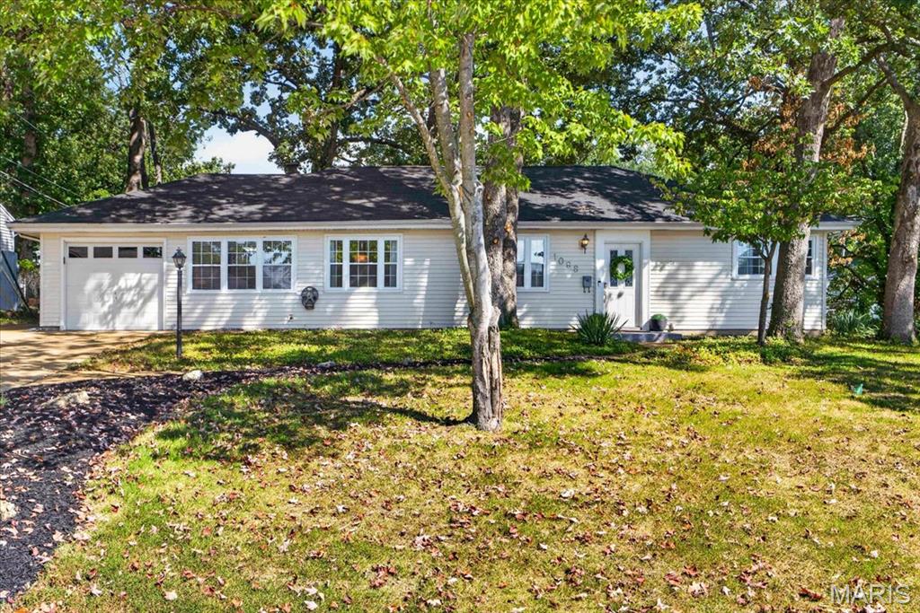 Superb Crestwood Location within the Sought After Lindbergh School District. This Charming Ranch home offers One Level Easy Living, Lots of Updates, & Lots of Charm! **Everything you need for comfortable everyday living is conveniently located on the Main Level, making this home incredibly easy and convenient to enjoy!** This Home features open Living Room and Dining Room and Wood Burning Fireplace with Black Glass Tile Surround, Crown Molding & Custom Trim throughout. Two Bedrooms have been Cleverly Modified and Combined for an absolutely Spacious Primary Bedroom! (could easily be converted back to 3 bedrooms) with Double Closets and Ceiling Fan. The Kitchen features Crisp White Custom Cabinetry, Granite Countertops, Stylish Tile Backsplash, Newer Stainless Appliances including 5 Burner Gas Stove, Dishwasher, Refrigerator (stays) and Tile Floor. A Breakfast Room for Casual Dining leads to the Patio & Large Fenced Backyard! The Main Floor Laundry is Super Convenient and has backdoor to the Patio (Washer and Dryer Stay)! Split Bedroom Floorplan provides 2nd Bedroom with Ceiling Fan. Renovated Full Bathroom has Herringbone Tiled Tub and Tile Floor. Newer (2023) Carpeting Throughout. Ample Storage, Lots of Closets, Lots of Character. Outside the Extensive Fenced Yard provides plenty of space for Patio dining, yard games or gardening projects. Impressive .27 AC Lot with Beautiful, Mature Shade Trees - all in a Central Location within Lindbergh Schools! Double Wide Driveway in addition to a Single Car Garage. Positioned in a Prime Crestwood Neighborhood with Convenient Access to Local Parks, Shopping and Dining, this Unique Property offers both Space and Flexibility. Please contact Nya Zitting with any questions 602-885-8141.