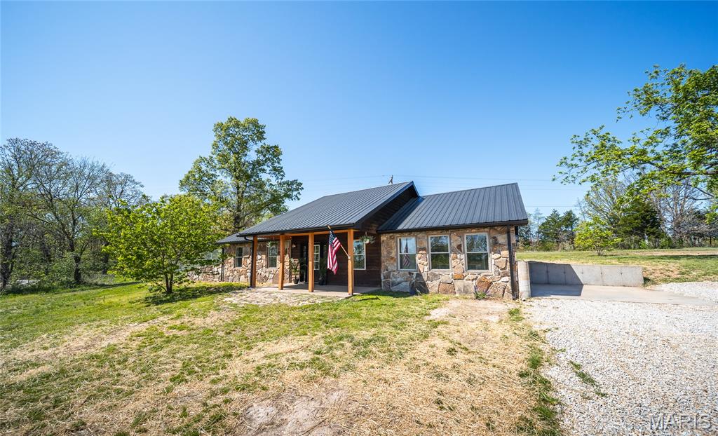 Enjoy the ease of one-level living in this beautifully updated 4 bed - 2 bath home on 7.81+/- acres, just outside Rolla city limits. This stone-accented home with cedar siding, and a durable metal roof offers both character and long-lasting quality. 
Inside you'll find numerous upgrades including new vinyl plank flooring throughout, updated kitchen w/new appliances, modern lighting, and more. Creating a clean, move-in ready feel. 
Step outside and take in the peaceful setting. A winding gravel drive leads you to a secluded homesite, complete with fenced yard perfect for pets and a spacious garden area ready for your homesteading dreams. 
The standout feature is the brand-new 20X40 shop, equipped with concrete floors, its own electric panel, 3 roll up doors, making it ideal for storage, hobbies, or home-based business. 
Private county living with the convenience of town just minutes away - this property truly offers the best of both worlds! Call today to schedule your private showing.