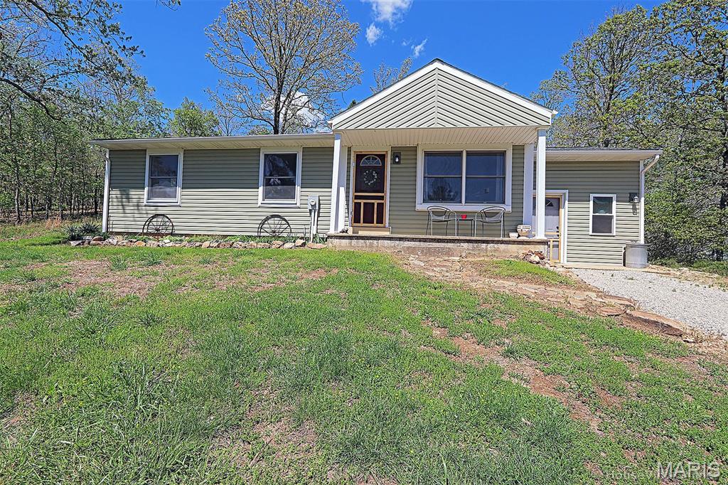 Dollhouse sitting atop with backdrop of woods.  High on hill on 12 1/2 acres M/L. Pasture and woods.  Little creek as you enter winding driveway to home.  All fenced and cross fenced with two sheds.  Bring your horses.  Government land across road for added privacy!