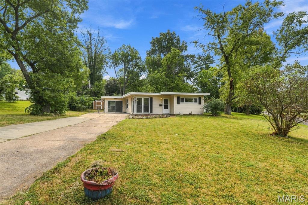 Take a look at this fantastic opportunity for an Owner Occupant or for your Investment Portfolio! Charming 2 bedroom ( possible 3rd bedroom /bonus room easily could be converted to a 3rd bedroom suite), 1 Full Bath home with an extended parking pad,  all on a large corner lot next to St Ferdinand Park. This home boasts an open airy floor plan perfect for entertaining or relaxing with family/friends. The kitchen is open to the 2 family rooms and offers ample counter space, wood cabinets and newer stainless steel appliances (Washer/Dryer and Fridge) ; which will ALL stay with sale of home! There are two family rooms for the family to spread out, a wood burning fireplace, and Georges floor to ceiling windows in the front room to let the natural light in. The fenced in back yard is HUGE with plenty of room for the dog and kids and family cookouts and don’t forget the large storage shed to keep all the essentials. The seller has already taken care of the major things for you like Water Heater, HVAC (Furnace and Ac unit ) all 3yr old and the Roof 2yrs old. All this with a convenient location to shops and right off of Hwy 67 in Florissant! Priced to sell! Home being sold AS IS.