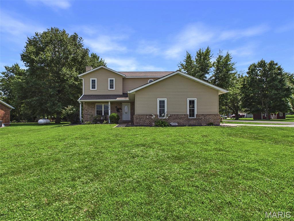 Welcome Home to this spacious 3BR/4BA Troy property, offering an abundance of living space, thoughtful updates, and an incredible detached outbuilding! Step inside to a large living room featuring a beautiful brick-surround fireplace, creating a warm and inviting gathering space. The spacious kitchen boasts gorgeous wood floors, a center island with seating, stainless steel appliances, and plenty of room for a large dining table. The adjacent laundry/mud room is both functional and stylish, offering built-in storage, a convenient drop zone with window seat, and a large pantry cabinet. Throughout the home, you'll appreciate quality details including solid wood interior doors and new carpet. The roomy, updated primary suite offers generous closet space and a spa-like private bath complete with a tiled tub/shower and double vanity. Two additional generously sized bedrooms and a remodeled full bath with tiled tub/shower complete the upper level. The finished lower level provides even more living space with a spacious family/recreation room plus a versatile bonus room—perfect for a home office, gym, playroom, or non-conforming fourth bedroom. The outdoor space is sure to impress! Enjoy relaxing or entertaining on the covered back patio with ceiling fan while taking advantage of the large corner lot. And for the hobbyist, car enthusiast, or anyone needing extra storage, the property offers an insulated and heated multi-car detached outbuilding with a full bathroom and shower, plus a separate rear-access storage garage ideal for lawn equipment and toys. Additional features include a two-car attached garage, water filtration system, and water softener. With its spacious layout, updates, fantastic outdoor space, and exceptional outbuilding, this Troy home offers the perfect combination of comfort, functionality, and versatility!