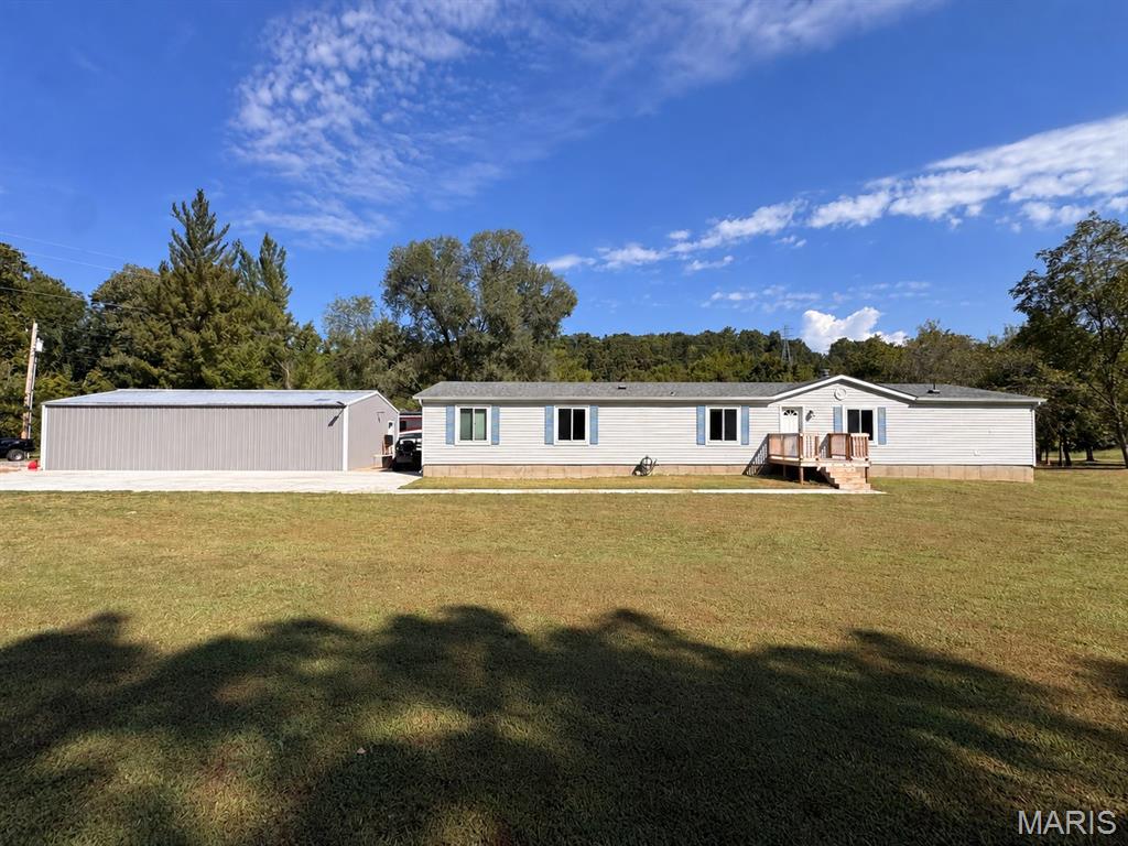 Discover space, privacy, and peaceful country living on approximately 5.78 level acres, this five-bedroom, three-bath home is permanently affixed over a poured-concrete crawl space. Recent improvements include upgraded 400-amp electrical service, updated lighting, a new exterior door, bathroom improvements, and updates throughout several additional rooms. The 24-by-40-foot detached garage features a concrete floor and new 100-amp electrical service. The property extends into a park-like setting with creek access, offering plenty of space to enjoy the outdoors. Schedule your showing to see everything this spacious property has to offer.