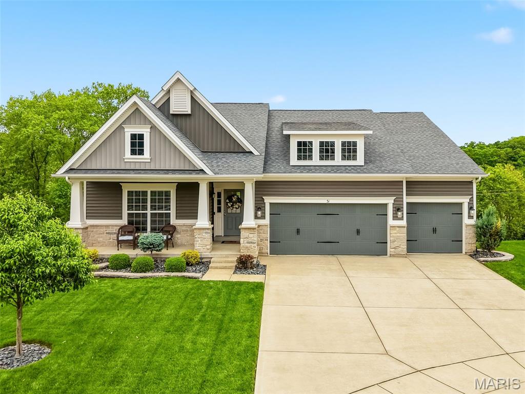 Nestled on a quiet, private (not-through) street and backing to serene woods, this stunning 5-year-old ranch blends peaceful surroundings with upscale living at every turn. Thoughtfully built by the original owner, the home showcases exceptional craftsmanship and luxury finishes throughout. The main level features soaring 9’ ceilings, a light-filled great room with a wall of windows framing picturesque wooded views, and a cozy fireplace that anchors the space. The beautifully appointed kitchen is a true centerpiece with a large breakfast bar island, granite countertops, tile backsplash, stainless steel appliances, and a spacious pantry, flowing seamlessly into both a formal dining room and a cheerful breakfast room with access to the composite deck, perfect for indoor/outdoor entertaining. The private primary suite is tucked in the rear wing of the home, offering a peaceful retreat complete with a walk-in closet and a spa-like ensuite bath featuring dual sinks, a soaking tub, and a separate shower. Two guest bedrooms and an updated full bath are situated on the opposite wing, providing ideal privacy and comfort. The finished walk-out lower level is designed for both entertaining and everyday living, boasting a spacious family room with a bar (bar fridge included), rec room, home gym with padded flooring, private office with French doors, a fourth bedroom with a walk-in closet, and full bath, perfect for guests or teens seeking their own space. Step outside to the patio and enjoy the irrigated tree-lined yard with an invisible pet fence. 3-car garage. This wonderful neighborhood includes a pool and playground and offers easy access to I-70/64/364 and all 3 Wentzville (Timberland High) Schools. What a beauty! See it today!