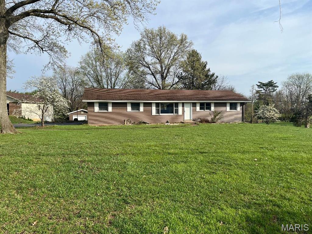 Welcome to 17370 Old Jamestown Road!  Come enjoy the Old Jamestown Area's "country" living near all suburban conveniences.  First time this home has been available for sale, ever!  This clean, bright and solidly built 3BR/2BA home has a finished LL, 2-Car side entry garage PLUS a 1-car oversized detached garage -- nearly 1,000 square feet of garage space here!  You can breathe a little and enjoy your two-acre slice of land here.  Newer hardwood flooring throughout main level (2024).  Spacious Family Room has beautiful ceiling beams, hand-hewn by the builder, plus a wall display niche and peg & plank hardwood flooring.  Pretty kitchen has been updated with quartz counters, stainless steel appliances, some decorative open shelving, plus newer ceiling fan.  Primary bedroom features double closets; two secondary bedrooms and renovated hall bath w/linen closet round out the main level.  Heading downstairs you'll find plenty of finished space with vintage charm, including a bar and another full bath.  Roughly half the finished space has been newly carpeted, and the remaining is in vinyl -- perfect for craft area.  Large covered back patio.  Great views -- rolling farmland out front and trees and countryside out back.  See this one today!