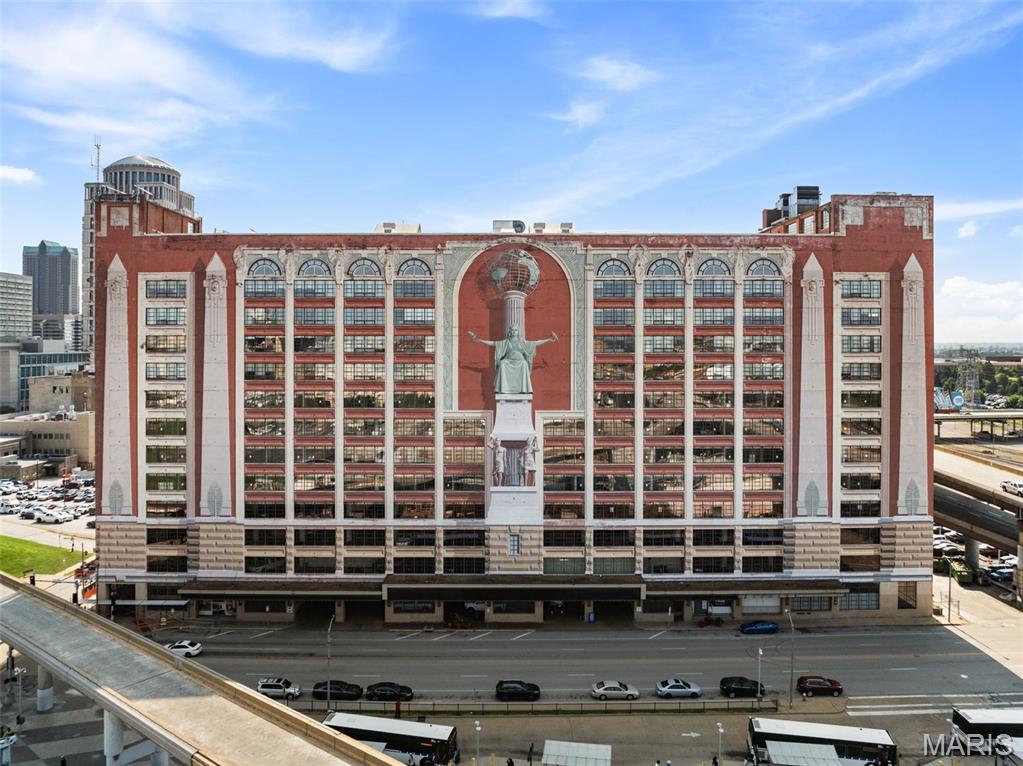 Live in the heart of St. Louis in a home that feels anything but ordinary. Set within the historic Edison building, this beautifully maintained condo pairs dramatic downtown architecture with thoughtful custom finishes and an exceptional kitchen designed for someone who actually loves to cook. The open-concept living space is framed by oversized windows and anchored by a cozy gas fireplace, while the gourmet kitchen features 42-inch cabinetry, a Viking range and Viking refrigerator, double ovens, generous workspace and a dedicated baking center. A separate wine center with wet bar and built-in ice maker makes entertaining effortless. When you want to take the cooking outdoors, residents also enjoy a common grilling area, offering another great space to gather and entertain without leaving home.

The spacious primary suite offers custom European-style cabinetry, a window seat, walk-in closet and a spa-inspired bath with rain shower, custom vanities and distinctive lighting. Throughout the home, custom lighting and finishes give the space a polished, sophisticated feel while preserving the character that makes loft-style downtown living so appealing.

And then there’s the location. Cardinals baseball, Blues hockey, St. Louis CITY SC, restaurants, entertainment and public transportation are all close at hand, with easy access to major highways and employment centers throughout the region. The historic building, originally constructed in 1929 and known for its remarkable Richard Haas trompe-l’oeil mural, is also poised for an exciting new chapter with a major renovation planned for the adjoining hotel space and the anticipated return of the Sheraton flag.

This is downtown living with room to cook, entertain and settle in, all in one of the city’s most recognizable historic buildings.