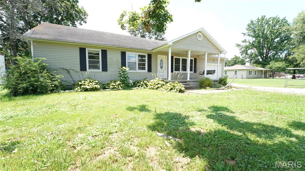 Welcome home to this charming 3-bedroom, 1-bath home located in the Dexter city limits, just a short walk from Dexter Public Schools! Featuring an inviting open floor plan, this home offers a spacious living area that flows seamlessly into the kitchen, complete with abundant cabinet space and a convenient pantry for extra storage. Luxury vinyl plank flooring runs throughout the home, providing both style and easy maintenance. The updated bathroom features a beautiful tiled shower, adding a modern touch. Enjoy year-round comfort with central heating and air. Outside, you’ll find a large covered front porch with a porch swing—perfect for relaxing with your morning coffee or unwinding in the evening. The chain-link fenced backyard offers plenty of room for kids, pets, gardening, or entertaining. A one-car garage provides additional storage and convenience with an added storage room off the back of the house. Don’t miss this move-in-ready home in a great location close to schools and everything Dexter has to offer. Schedule your private showing today!