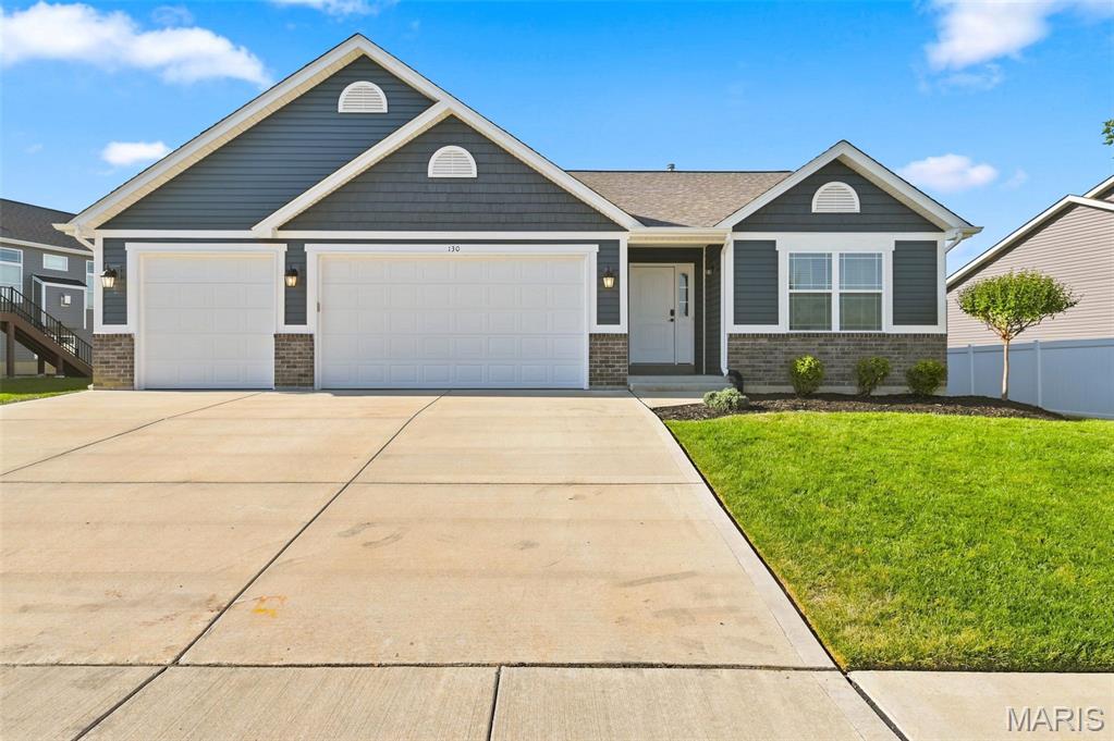 Welcome home to this beautiful 4-year-new split-bedroom Ranch with 4 Bed, 3 Full bath, 3 Car Garage, Maintenance Free Deck, Finished lower level and main floor laundry in the desirable Hampton Grove Subdivision! Open great room to a spacious kitchen and dining area w/12' ceilings, creating an easy, inviting flow for everyday living and entertaining. The kitchen features a large eating/prep island, stainless steel appliances with gas stove, granite countertops, upgraded cabinetry, and a slider leading to the maintenance free deck and fenced, level backyard—perfect for summer BBQs, play space, pets, and gatherings with family and friends. The spacious primary suite offers 10-foot ceilings, a coffered accent, room for a sitting area, and a luxury bath with a freestanding tub, walk-in shower, and double vanity. Two additional bedrooms, a full bath, and convenient main-floor laundry with storage cabinets complete the main level. The finished lower level adds even more living space with a 4th bedroom, full bath, large rec room with recessed lighting, and plenty of storage. (space for the In-Laws, guest or growing family) Located in highly rated Wentzville Schools near parks, restaurants, shopping, and entertainment, this home is move-in ready and available for a quick closing—Ready for you to call Home Sweet Home!