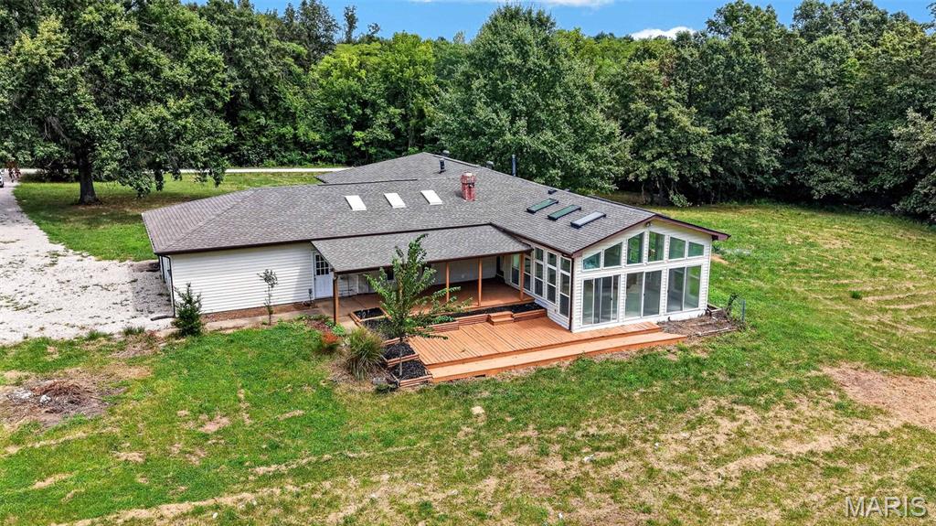 Showings start Friday, open house Sunday 2-3pm! A beautiful 2,700+ SF ranch home on a private and unrestricted 4+ acre lot in Warren County, MO. The seller has spent considerable time and detail to the finishes to ensure decades of enjoyment. Some large ticket items include a new well and new roof, brand new laminate flooring throughout. The kitchen has been completely redone with white cabinets, granite counters and appliances. There is a living room, a family room, a large 24 x 21 four season or sunroom with a tile floor. The family room has a wood burning fireplace and syylights. The primary bedroom has plenty of closet space, a generous ensuite and a deck off the back. Four bedrooms and three full baths are also on the main level. The covered deck is a beautiful area to gather. Attached and oversized 2 car garage. The lot itself is roughly 2 acres open and 2 acres wooded. A shop / barn is in the woods if you feel like a walk through the trees (it does need some work ) The location is just a few miles North of Highway 70, off of Highway W.  There are other beautiful homes along the road and in this area.
