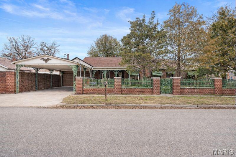 Welcome to this charming and spacious 4 bedroom, 2.5 bath home offering approximately 2,500 sq. ft. and situated on a corner lot. Featuring multiple living areas, two fireplaces, and a built-in bar, this home provides great space for entertaining and everyday living. The upstairs bedroom and full bath offer a separate living space, while outdoor sheds provide additional storage.  Enjoy the screened in porch, perfect for relaxing outdoors.  An additional room offers the potential for a 5th bedroom or office.  A solid home with character and room to personalize, ideally located with quick access to town amenities.