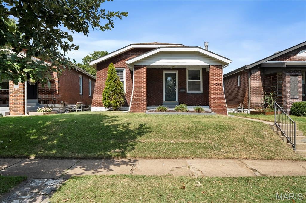 Welcome to 4035 Utah...a true Tower Grove South charmer! Nestled on a fantastic block, this charming 1922 full-brick bungalow perfectly blends classic South City character with the modern amenities today's buyers crave. Step inside to find a sun-drenched living space showcasing beautiful historic millwork, updated flooring, and a cozy fireplace serving as the perfect focal point. The separate dining room flows into an updated kitchen boasting custom cabinetry, granite countertops, and stainless steel appliances. A stellar rear sunroom addition offers the perfect layout for a bright home office, creative studio, or prime drop-zone. Outside, the level, fully fenced backyard is an oasis for summer patio parties, leading to a rare find for the neighborhood: a massive brick garage. With incredible walk score—just steps from Tower Grove Park, the South Grand dining strip, and Morganford favorites—this move-in-ready charmer won't last long!