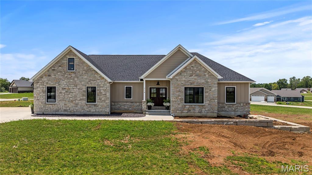 Welcome home to this beautifully designed residence featuring eye-catching stone accents and an open floor plan with vaulted ceilings. The heart of the home is the spacious living area, highlighted by a unique see-through gas fireplace that connects seamlessly to the covered back deck—perfect for entertaining or cozy evenings indoors and out. 
The chef’s kitchen shines with ZLINE appliances, a generous center island, and a walk-in pantry—ideal for everyday living and hosting alike.
The main level offers four bedrooms and two full baths in a desirable split-bedroom layout for added privacy. Retreat to the private primary suite featuring a spa-inspired bath with soaking tub, walk-in shower, double vanities, and a large walk-in closet.
Downstairs, the finished lower level expands your living space with a family room, third full bathroom, a room currently used as a gym, plus an additional room previously used as a salon—offering endless possibilities for home office, hobby space, or guest accommodations.
Outside, enjoy a partially privacy-fenced backyard complete with pet turf, creating a low-maintenance area for furry friends and outdoor fun. With thoughtful design, flexible spaces, and modern comforts throughout, this home truly checks all the boxes. Schedule your private tour today—you won’t want to miss it!