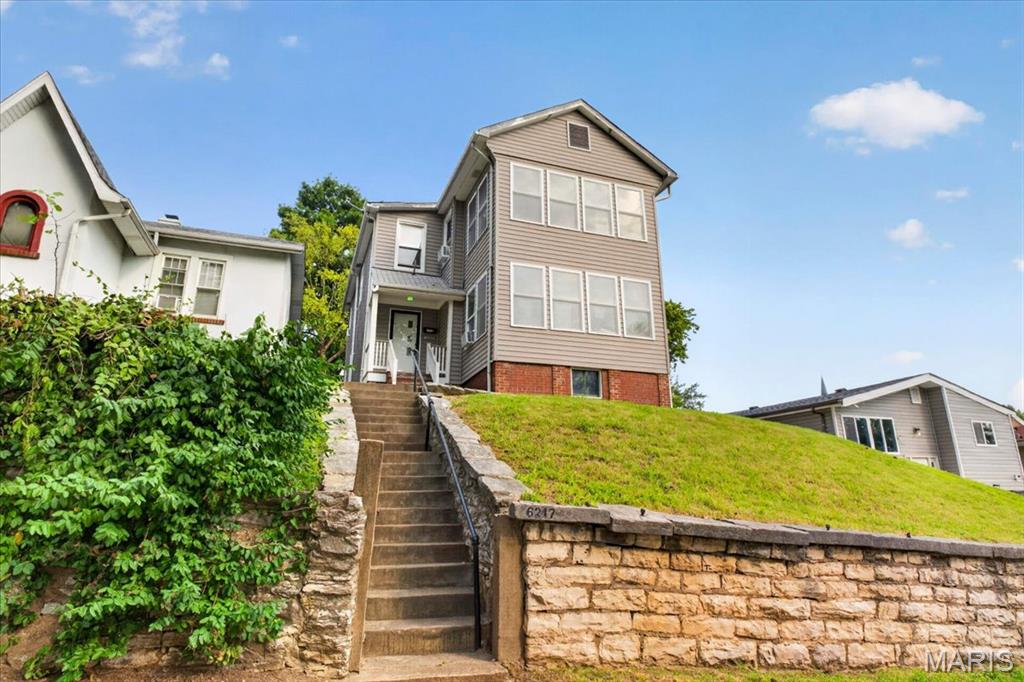 Secure an income producing asset with deep roots in the Carondelet market. This circa 1870’s two-family residence offers a rare combination of historic character and long-term stability, having been meticulously maintained by the same family for over 100 years. Perched on a hilltop, the property provides unique Mississippi River views and a commanding presence that sets it apart from standard inventory.  For the investor looking to scale or solidify a portfolio, the operational setup is turnkey. The property features two 1-bedroom units designed for maximum efficiency. One unit is currently occupied by a month-to-month tenant, ensuring immediate cash flow from day one. The second unit is vacant and move-in ready, allowing for immediate market-rate leasing or a value-add refresh to further drive NOI.  This is a clean, well-preserved building that reflects a century of pride in ownership. It offers the structural integrity of a legacy asset with the flexibility to modernize and capture higher rents. To streamline the transaction, the seller prefers an "As-Is" sale on a Special Sales Contract. Capitalize on this rare opportunity to acquire a historic income-producer with an unbeatable vantage point.