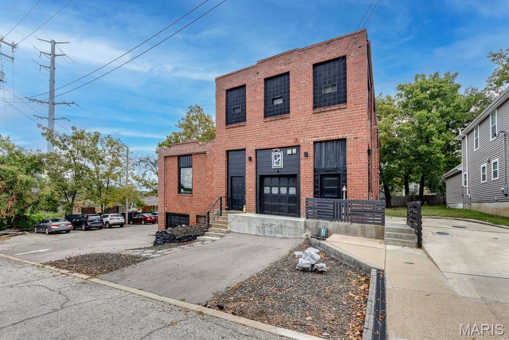 Have your (Investment) cake and eat it too! Once in a lifetime opportunity to acquire one of the most unique live/work buildings you have ever seen, located in central and highly desirable Maplewood. Smart, contemporary renovation by current owner, this 7800 +/- sf  former light industrial building has tons of open creative/work spaces on the first floor and a massive 3 bedroom/2 bath loft-style living space on the 2nd floor. Soaring ceilings on both levels, loads of natural light with new windows throughout, new roof, tuckpointing, hvac, and plumbing updates make this a low-maintenance property. Loads of parking with parking lot on the west side of building and additional spaces. Situated just 1 block off Big Bend Blvd in a private cul-de-sac with excellent access to I-40/I-44. Second floor currently rented to traveling nurses. Many possibilities here - live upstairs, have your business downstairs. Or live upstairs and lease the first floor to one or several businesses wanting a unique, loft-style work environment. Or, lease out the whole building and be the proud owner of the coolest investment property in St. Louis County. Owner's business occupies part of 1st floor space and they would consider a sale-lease-back if desired. 2 car-deep garage in front provides additional storage space, or rent the garage for additional income. Separate 2 story barn on premises for additional storage or possibility to build-out into an additional rental apartment. PUD permitted uses include 1 three bedroom apt, co-working space up to 4400 sf per City of Maplewood.