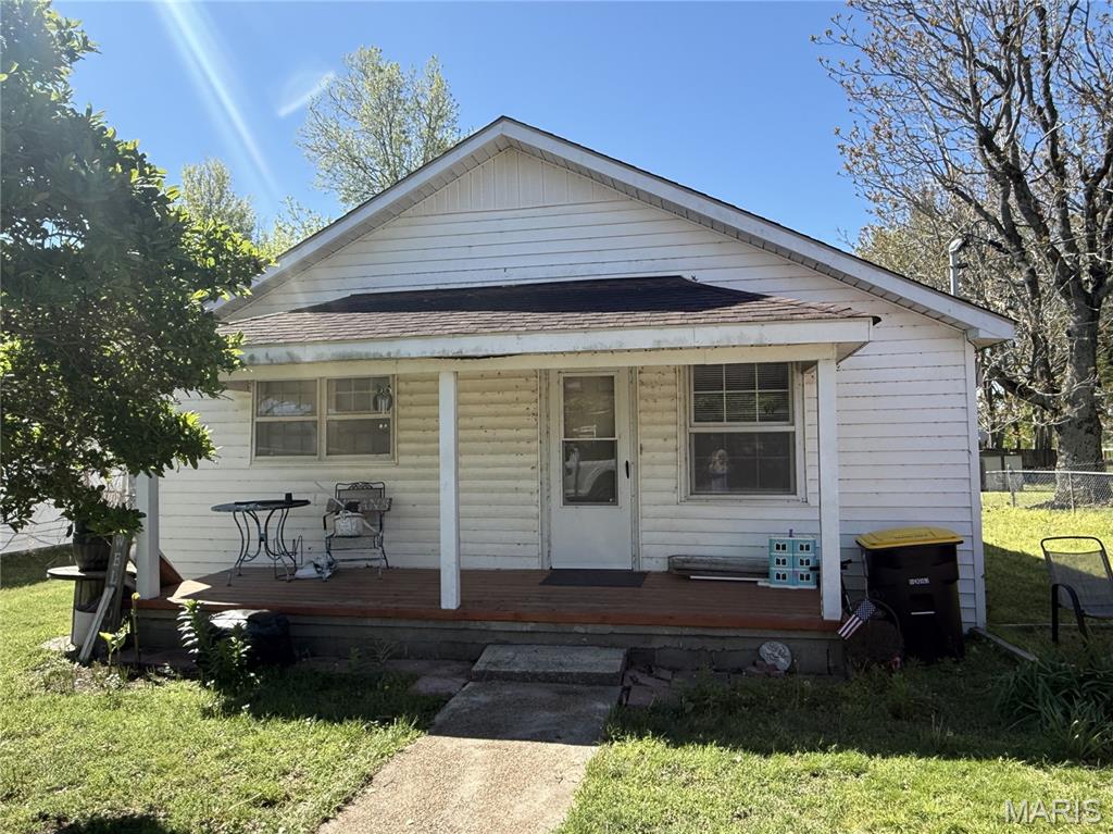 This home offers 2 good sized bedrooms and one bath. Nice living area and open dining area and kitchen.  The  Kitchen has a center island/ sink. Off the kitchen there is a laundry room. The chain link fenced backyard has plenty of room for play or a workshop. The front porch is just right for porch sitting! Storage building included. Lot size 60X144.5