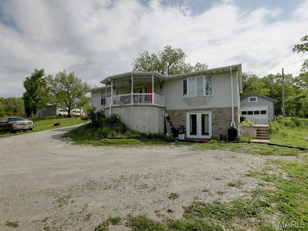 ADDITIONAL ACREAGE ADDED! Are you dreaming of your own piece of paradise out in the country? Look no further, this one is sure to check all the boxes! This well maintained 3-bedroom, two-bathroom home sitting on 9+/- ACRES is perfect for all of your farm and homestead needs. Walking through the house the first thing you notice is the large covered front porch, moving into the entry way you'll find the living room complete with tons of natural light, the dining room/mud room, kitchen, and laundry room all on the main level. Two bedrooms and a bathroom complete the main floor. Downstairs you will find a freshly remodeled living space with a bedroom and another full bathroom. The home has a NEW metal roof and features not one but TWO additional outbuildings, both with NEW metal roofs as well. The FIRST OUTBUILDING is an oversized 24x15 garage right off the back patio - it has just been sided with new metal all the way around the building. The SECOND OUTBUILDING is 30x40 and is an excellent shop as well as provides space to store all your equipment. Also, let's not forget about the POND! Another option with this great property is the opportunity to purchase additional acreage!