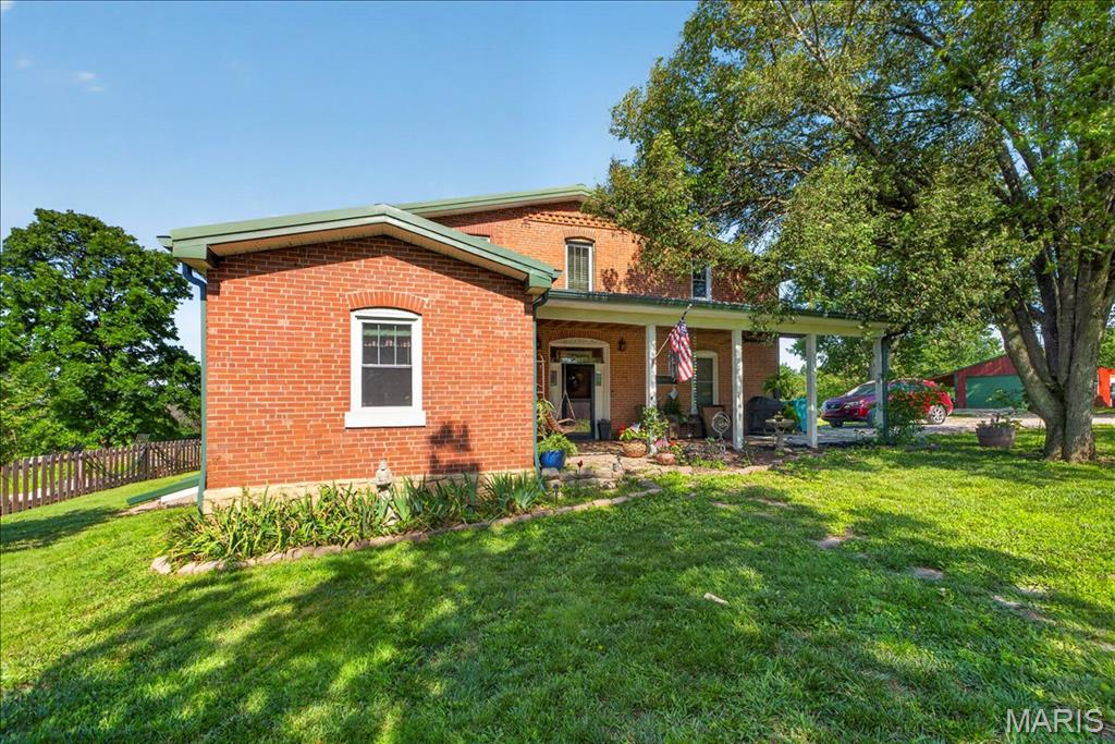 Beautifully Updated Historic Farmhouse on 2 Acres with Breathtaking Views!

Step back in time without sacrificing modern comfort in this charming 1865 farmhouse nestled in the rolling countryside of Franklin County. From the moment you arrive, you’ll feel the peace and privacy that only rural Missouri can offer — yet this property lives far larger than its 2 acres thanks to stunning, unobstructed views overlooking the neighboring farm and woods that stretch for miles. Relax on the deck or in the hot tub watching the beautiful sunsets night after night.

Inside, you’ll find a warm and inviting layout filled with rustic character — an exposed brick accent wall anchors the spacious living room. The updated kitchen is a is perfect touch, blending farmhouse charm with modern finishes — perfect for the buyer who loves to cook and entertain. Main floor laundry and a full bath add everyday convenience, while the upstairs master suite and guest bedroom offer privacy and rest.

Outside, the property truly shines. A new detached oversized garage adds parking and storage, and a charming brick outbuilding adds even more versatility — workshop, studio, storage, the possibilities are endless. A ready-to-go chicken coop makes this an ideal setup for anyone dreaming of a self-sufficient homestead lifestyle, and the beautifully maintained garden area completes the picture. Whether you’re sipping coffee on the porch watching the sunrise over open farmland or tending your garden on a quiet morning, this property delivers a lifestyle that’s hard to find and impossible to forget.

Located in the highly regarded Union R-XI School District and just a short drive from the shops, dining, and amenities of Washington, MO, you get the best of both worlds — true country living without sacrificing convenience.

If you’ve been dreaming of a peaceful country retreat with space, character, and views that feel like 100 acres — this is it. Schedule your showing today before it’s gone!

Please no drive-by’s. Private driveway with traffic sensor.