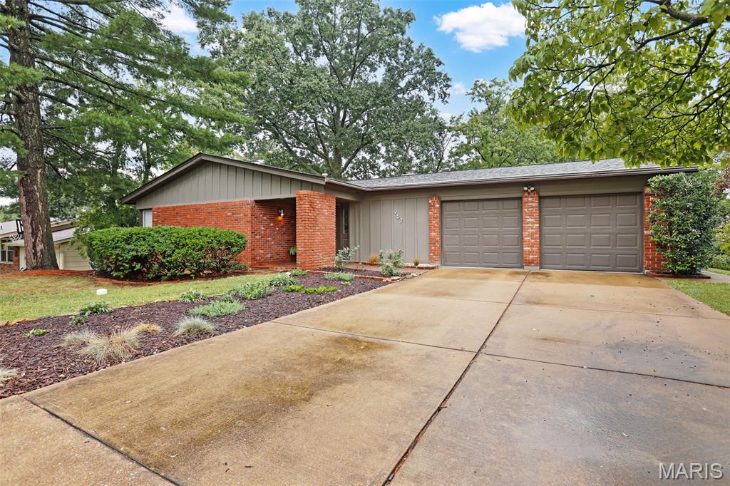 Welcome to 957 Flair Ct., a stylish 3-bedroom, 2-bath ranch tucked away on a quiet cul-de-sac. Mid-century modern influences, beautiful hardwood floors, expansive windows and abundant natural light give this home distinctive character and a warm, inviting feel. 
The bright white kitchen features stainless steel appliances, generous cabinetry and a skylight, while the spacious family room is anchored by a dramatic floor-to-ceiling brick wood-burning fireplace with direct access to the outdoor living area. Separate living and dining spaces provide plenty of room for both everyday living and entertaining.
The expansive walk-out lower level offers incredible flexibility for a home gym, recreation, hobbies or future finished living space, along with abundant storage. A fenced yard with mature trees, spacious 2-car attached garage and convenient Parkway School District location complete this wonderful home.