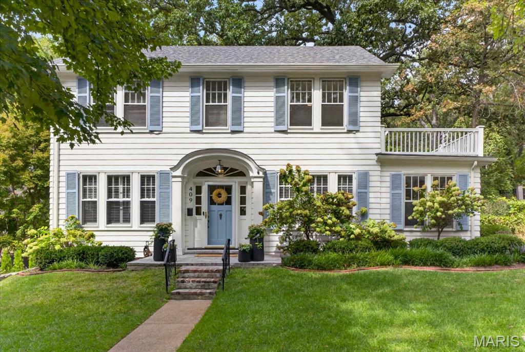 Welcome home to 409 Belleview Avenue, a beloved Webster Groves home filled with warmth and character. This classic two-story, center-entrance Colonial pairs timeless details with thoughtful updates in a setting made for everyday life.

A gracious front hall welcomes you with nine-foot ceilings, substantial seven-inch baseboards, and original architectural details. The traditional center-hall floor plan opens to a spacious living room and generous dining room, creating a wonderful flow for daily life and gatherings with family and friends. A light-filled sunroom with built-in bookcases offers a peaceful and flexible space. The updated kitchen blends modern function with the home’s history, including its original working Magic Chef oven.

Upstairs are three bedrooms, including a spacious bedroom with access to a private outdoor deck.

Outside, mature landscaping and perennial gardens create a beautiful backdrop throughout the seasons. Large raised vegetable beds, a generous deck, and plenty of room to play, garden, and gather make the backyard a true extension of the home. A detached two-car garage completes the property.

Best of all is the Webster Groves lifestyle just beyond your door. Walk to schools, parks, cafés, restaurants, shops, and downtown Webster, all while enjoying the warmth of an established neighborhood and community.

Plant your kitchen garden, fill your dining room table, welcome friends and neighbors, and make traditions of your own at 409 Belleview Avenue.

A timeless Webster Groves home, ready for its next chapter.