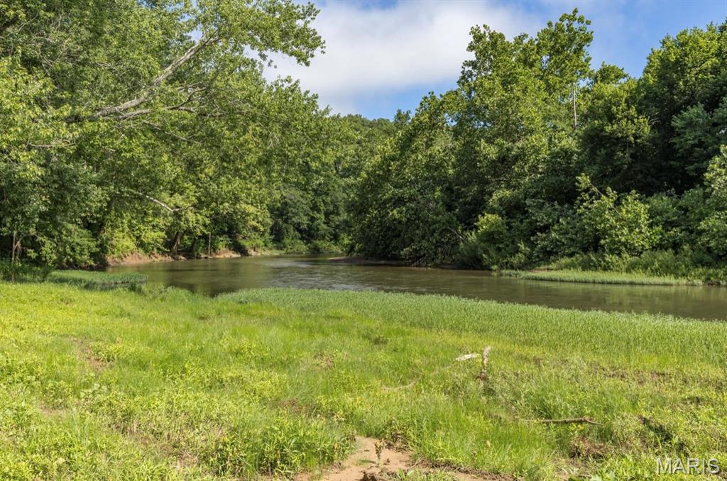 84.52 Acres with Big River Frontage | Off-Grid Cabin | Natural Spring. Escape to your own private retreat with this recreational paradise featuring approximately 600 feet of Big River frontage. This beautiful property offers the perfect blend of seclusion, natural beauty, and outdoor opportunity. The land is a hunter’s dream, with a mix of timber, rolling terrain, and abundant wildlife including deer and turkey. Whether you're looking for a premier hunting property, weekend getaway, or a place to unplug and enjoy nature, this tract delivers. A rustic off-grid cabin provides a cozy basecamp for your outdoor adventures. The property also features a natural spring, offering a valuable water source and adding to the land’s unique character. With direct access to the Big River, you can enjoy fishing, floating, and relaxing along the water’s edge. The expansive acreage provides endless possibilities for recreation, trail riding, camping, or creating your own secluded homestead. Properties of this size with river frontage, a spring, and a cabin are hard to find. Don’t miss the chance to own a remarkable piece of Missouri land.
Note:  Well present on property. Seller has not used the well and makes no representation as to its condition or functionality