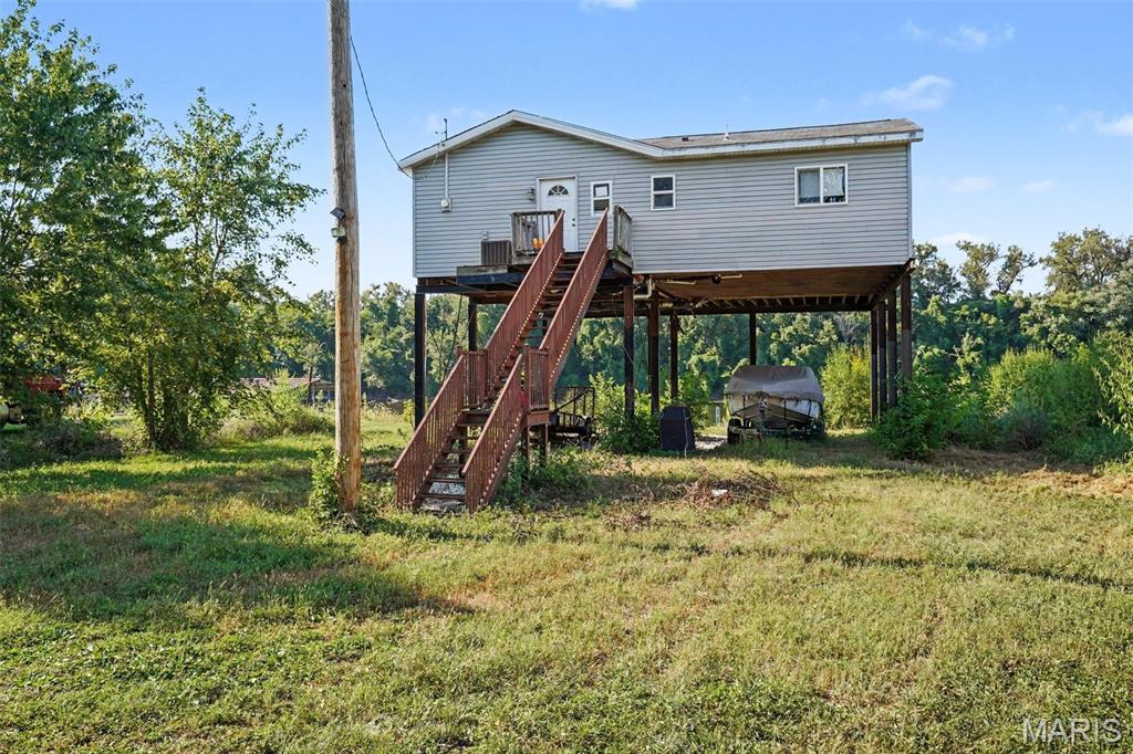 Looking for a property along the river?  Look no farther....this 2 bed, 1 bath home has a 12 by 36 boat dock/slip with a sun pad, vinyl siding, walk in shower, and is built 16 ft in the air as it is in a flood plain.  The land does flood at times every 7 years. Deck needs some TLC. Make your appointment today! Buyer and buyers agent to verify all MLS information including measurements.