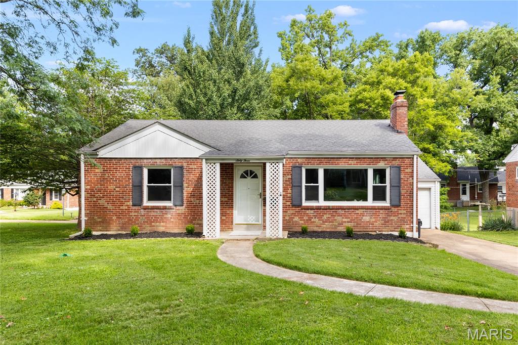 Welcome to this beautifully renovated brick bungalow in a great Webster location! Situated on a spacious corner lot shaded by trees, this home invites you inside to the bright living room with new hardwood floors and a brick-surround fireplace. The living room opens to the dining room with a stylish chandelier. The kitchen features quartz counters, modern black fixtures, stainless steel appliances, a classic tile backsplash, tile floors, and plenty of cabinet space. The updated bathroom has a tile-surround shower, quartz vanity, black fixtures, and new tile floors. Two spacious bedrooms with hardwood floors complete the main level. The finished basement adds a family room, storage space, and a laundry room. You'll have even more storage in the one-car garage with its own exit to the backyard. Just moments from Webster Rec Plex and Memorial Park, Webster Schools, I-44, and all of the shopping and restaurants in Downtown Webster, and along Watson Road, this move-in ready home is just waiting for its new owners!