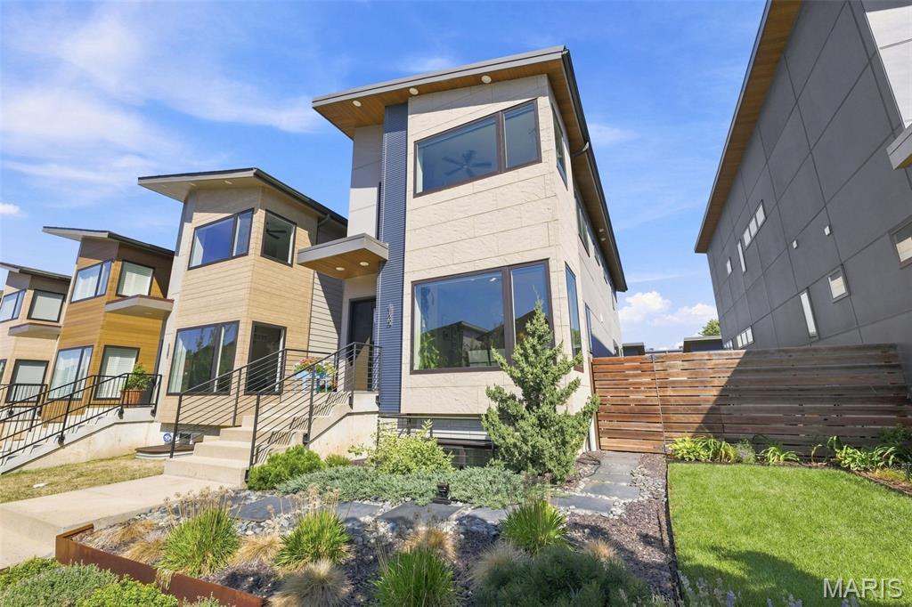 This exceptional 4 bed, 2.5 bath Energy Star-certified custom home stands in a class of it's own, custom built with additional features designed to last a lifetime. This home sits in the heart of The Grove; where amazing food, culture & over $60M in development is right out your doorstep! Home offers nearly 2200 sq ft of luxurious living. Thoughtfully designed with top-tier upgrades throughout, featuring a chef’s kitchen with quartz countertops, stainless steel appliances, custom cabinetry, seamless backsplash, and a large island. Enjoy the warmth of hardwood floors, Anderson windows, zoned high-efficiency HVAC, and 50-year standing seam metal roof. The spacious owner’s suite includes custom double closets and a stylish tiled shower. Upstairs also offers two additional bedrooms, a full bath, and convenient laundry. Closets are finished with an "Elfa" closet system, maximizing style and organization throughout. One of the few homes in the area with a finished walkup/ out basement—complete with tall ceilings and an extra bedroom! On the outside, relax on the beautiful deck with gas grill hookups and custom landscaping! Beautiful and quiet living with space to entertain, this home is cozy and convenient. An oversized two-car garage and SOLAR panels power this rare offering in one of the most sought-after neighborhoods. Additional specifications, solar details and property plans available upon request. This home was built and finished to impress!