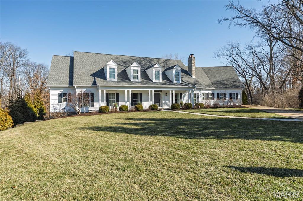 Exceptional custom Frontenac home tucked away on a private cul-de-sac and designed for entertaining. Open floor plan with detailed millwork, hardwood floors, designer lighting, and 10' ceilings on the main level. The great room features a beamed ceiling and dramatic floor-to-ceiling limestone fireplace. Light-filled dining room and private wine room with custom built-ins. Gourmet kitchen with custom cabinetry, Viking appliances, quartz counters, walk-in pantry, and butler’s pantry with ice maker and beverage refrigerator. The main floor also features a large covered patio with a built-in grilling area—ideal for outdoor entertaining. Two main-level half baths plus oversized laundry/mudroom with custom lockers and abundant storage. Luxurious primary suite with massive custom closets and spa-inspired bath featuring decorator tile and oversized shower with three heads. Private sitting retreat with fireplace overlooks the completely private backyard oasis with pool featuring waterfall and hot tub. Upstairs offers four ensuite bedrooms and a second-floor living area, including an ideal in-law or nanny suite with access to a pre-framed elevator shaft for future installation. Walk-out lower level includes custom bar, two beverage refrigerators, kegerator, designer lighting, custom bath, exercise room, and private office. Oversized 3-car garage. Refined craftsmanship, resort-style amenities, and an exceptional layout ideal for both everyday living and entertaining.