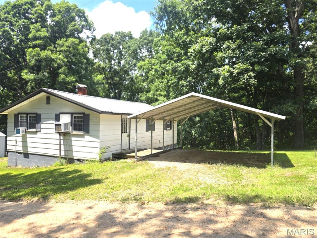 Do you want an acre of privacy in Puxico School District?  This home sits near the end of a dead-end road.  Nothing but woods in the front and back!  Talk about privacy.  This is it!  This 2-bedroom, 1-bathroom home has a large, eat-in kitchen with a lot of cabinets, a deck for you to sit, relax, and enjoy the wildlife roaming in your backyard.  This home has storage under part of the home as a "partial basement" with an outside entrance.  The metal carport stays with the sale.  There is also a spacious shed on the property for convenient storage!  (More pictures coming soon!)