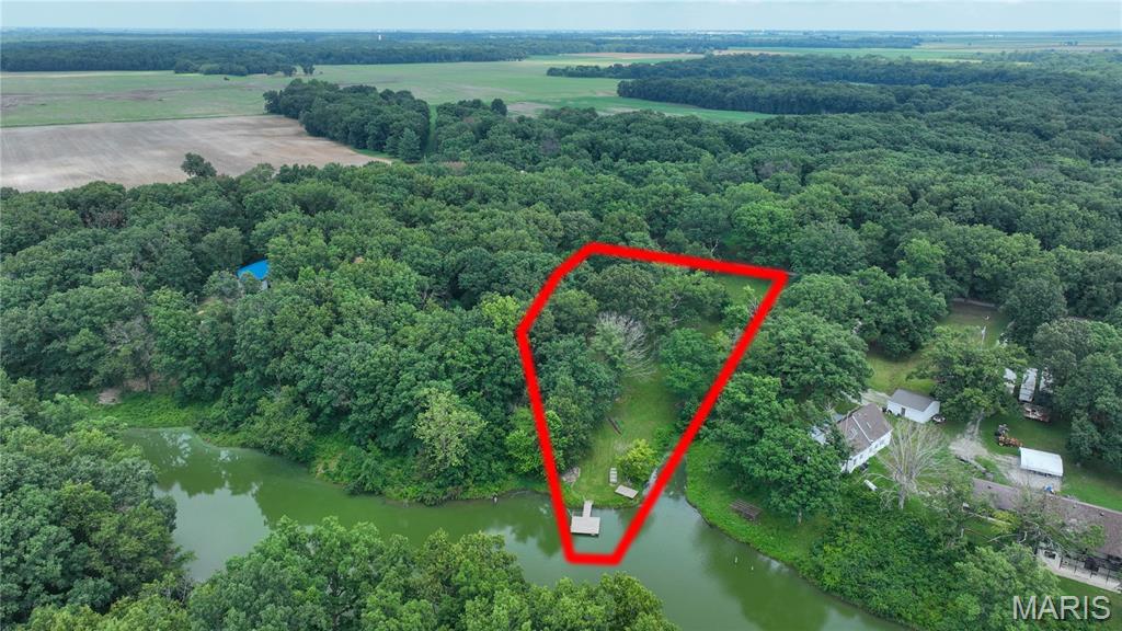Beautiful, secluded lakefront lot just minutes from Interstate 55.  Build your dream home on this beautiful 3 acre lakefront lot.  Partially wooded, there are many homesites on this lot that could include a walk-out basement.  A lot of the prep work has been done for you.  Water is connected and active.  Power has been run to the center of the property, the shed, and the dock with plenty of capacity for building your dream home.  Come take a look at this lakefront lot in a very secluded, quiet area.  Homeowner is responsible for 6% of the lake and dam maintenance fees (seller has paid $0 in the 5 years he's owned it).  Lot may be used for residential or recreational purposes only - public facing businesses are not allowed.  Ask your Realtor for more information and a private showing today!