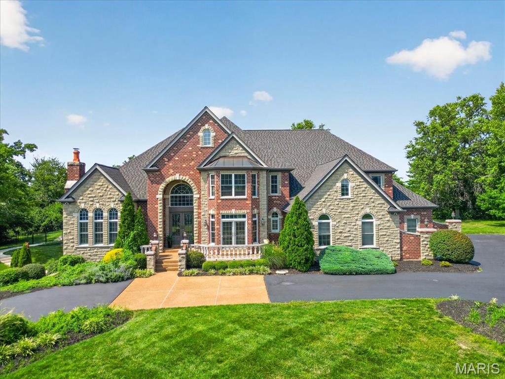 Timeless French Provincial architecture defines this exceptional estate, gracefully positioned on 1.34 private acres in prestigious Chapel Hill Estates. With over 10,000 square feet of finished living space, this 5-bedroom, 5 full and 2 half bath residence was thoughtfully designed for both grand entertaining and comfortable everyday living.

A dramatic two-story foyer with marble flooring and a sweeping curved staircase welcomes you into this remarkable home. Just off the foyer, the private library features custom built-ins, French doors, hardwood floors, plantation shutters, and a fireplace, creating an elegant retreat for work or relaxation. Across the foyer, the formal dining room offers an inviting setting for intimate dinners or memorable holiday gatherings with plenty of room to accommodate family and guests. Continue into the heart of the home, where the impressive two-story family room makes a lasting impression with its soaring floor-to-ceiling stone fireplace and spectacular wall of windows that flood the space with natural light.

The gourmet kitchen is designed for both everyday living and entertaining, featuring custom cabinetry, granite countertops, Thermador and Bosch appliances, large center island, walk-in pantry, wine cooler, breakfast bar, and abundant prep space. The adjoining hearth room offers a second fireplace and spacious sitting area, creating a warm and inviting gathering space just off the kitchen.

The luxurious main-level primary suite offers a coffered ceiling, private sitting room with fireplace, dual walk-in closets, and a spa-inspired bath featuring separate vanities, steam shower, and whirlpool tub. Upstairs are four spacious bedrooms, three full baths, an expansive loft area, and a second staircase providing additional convenience.

The walk-out lower level is designed for entertaining with a home theater, recreation room, game room, exercise area, full kitchen, full bath, and direct access to a spacious patio. Hardwood flooring extends throughout the main and upper levels. Outdoors, enjoy a private, tree-lined backyard with a saltwater pool, expansive patio, and the exceptional privacy afforded by this estate-sized homesite.

Additional amenities include 9' and 11' ceilings on the main level, 10' lower-level ceilings, 8' doors, transom and Palladian windows, irrigation system, security system, intercom, built-in speakers, and an oversized four-car garage.

An exceptional opportunity to own a truly special home in Chapel Hill Estates.